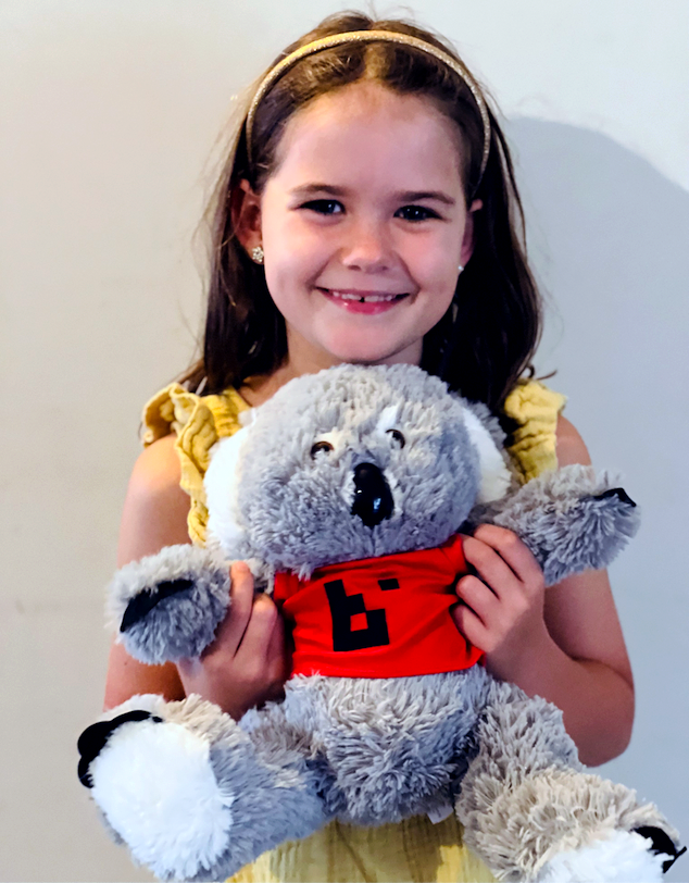 Girl holding BART 'Bartholomew' koala